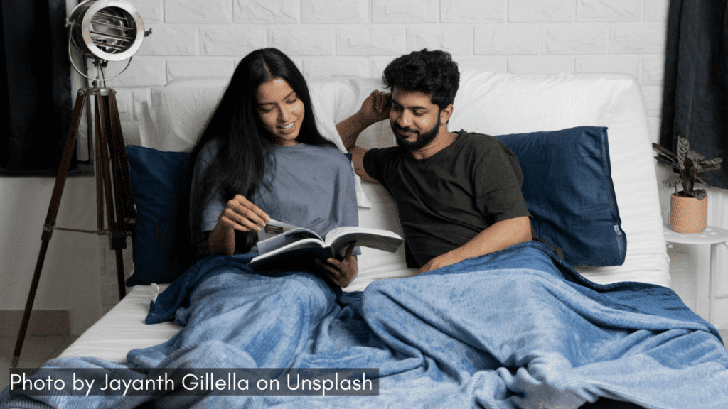 a couple enjoy a rainy day reading a book