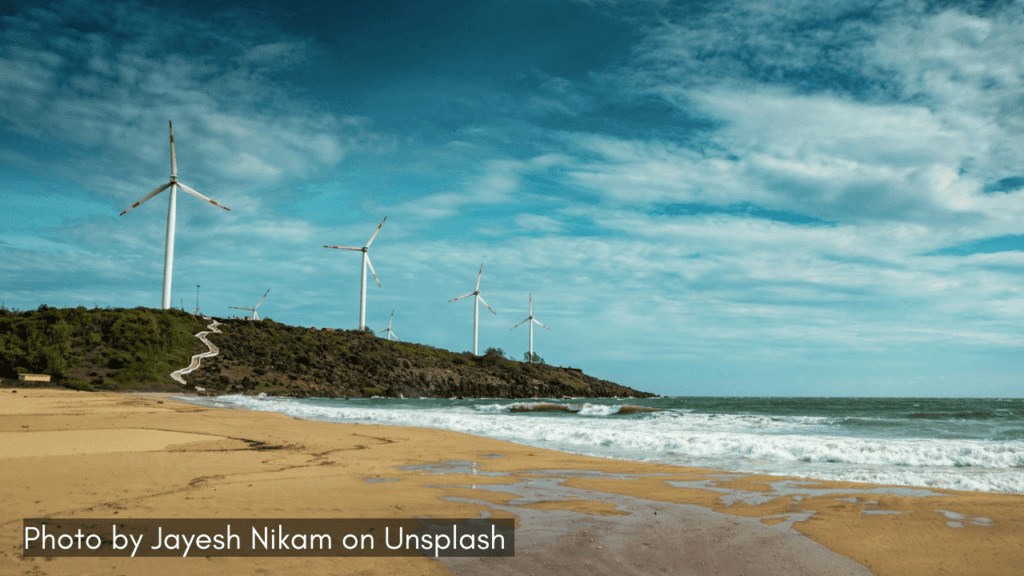 a view of devgad beach with windmills in the background