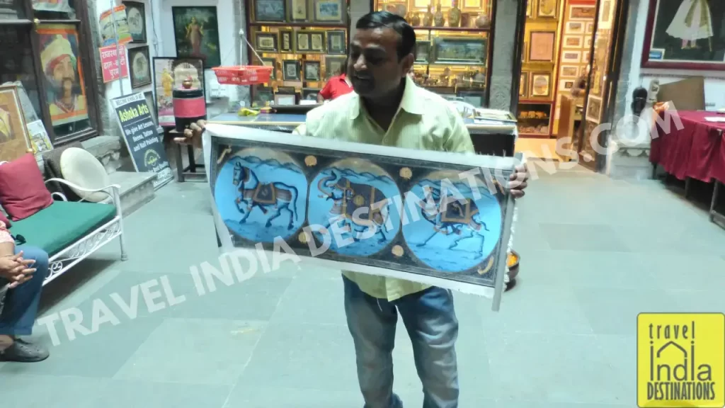 a tour guide explaining about how to go art shopping in udaipur