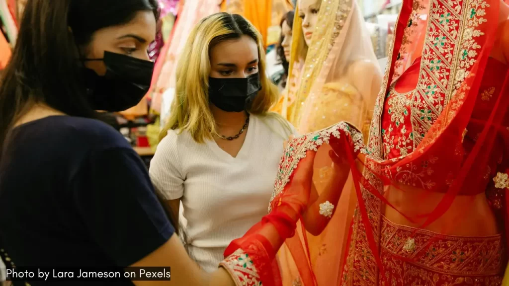 two girls shopping indian ethnic clothes to celebrate navratri