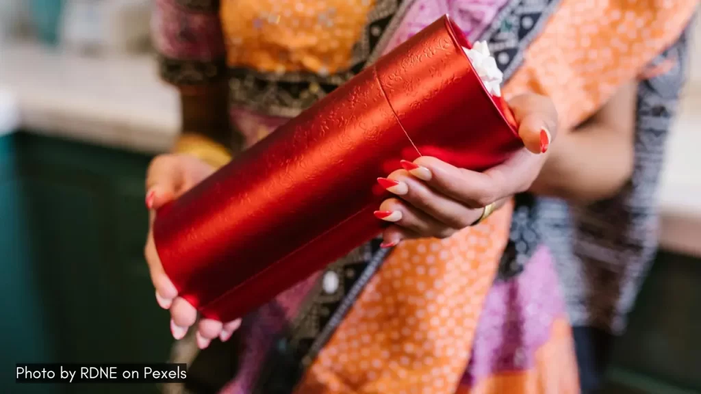 a girl giving gift to celebrate navratri at home