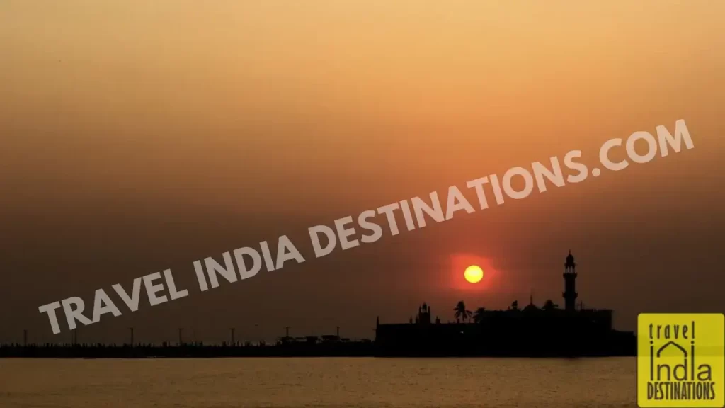 A golden sunset view with the silhouette of Haji Ali shrine near Worli.