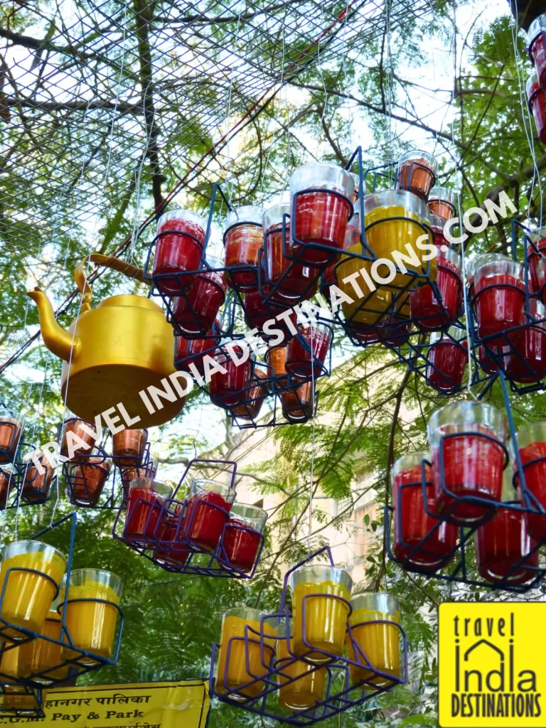 cutting chai glasses and tea kettle hanging as installation at kala ghoda arts festival in mumbai