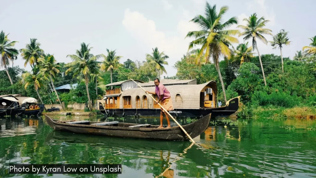 man rowing a boat in alleppey kerala