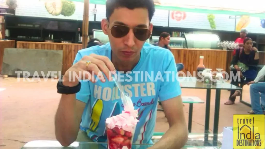 sharukh relishing strawberry ice cream milkshake at Mapro Garden in mahabaleshwar