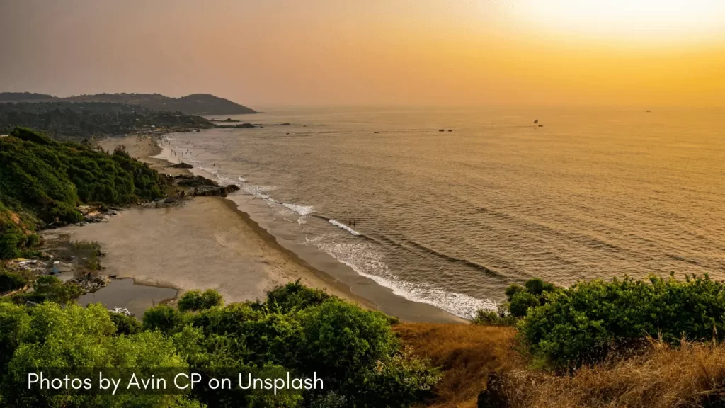 a view of the vagator beach in goa during sunset hours