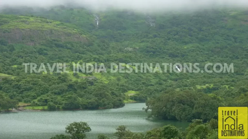 The reservoir of Bhushi Dam Lonavala, with calm waters surrounded by lush greenery.