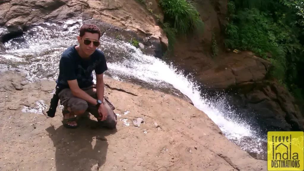 Sharukh Bamboat posing near a stream flowing near the dam