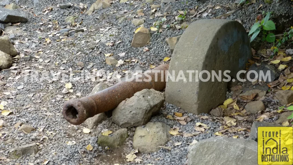 A small cannon lying at the base of the Lohagad Fort