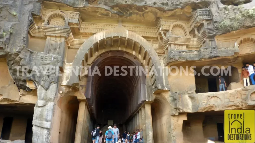 Bhaja Caves Chaitya hall with visitors exploring the arched ceiling and ancient Buddhist architecture.