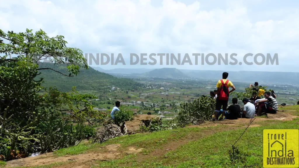 Hikers taking a break and enjoying panoramic views of the Sahyadris