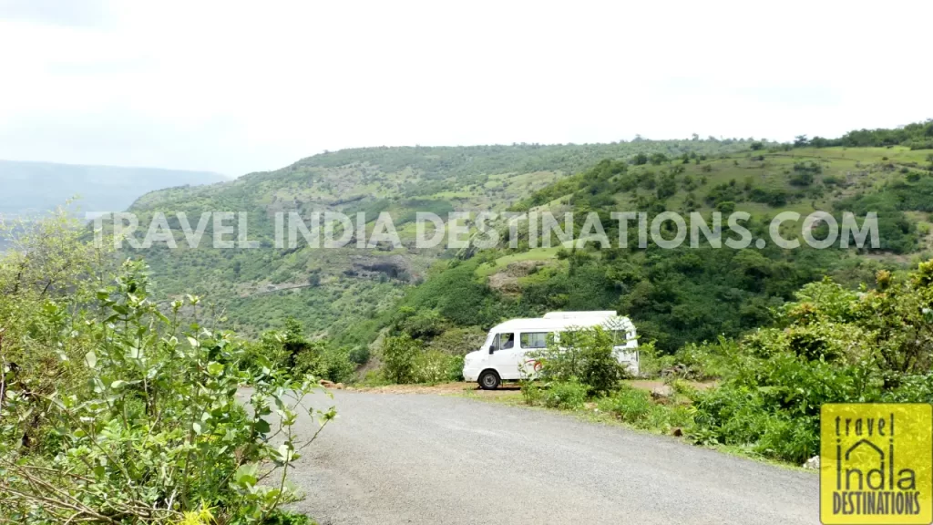 A view of the Lohagad-Visapur Fort trek road with Bhaja Caves in the backdrop