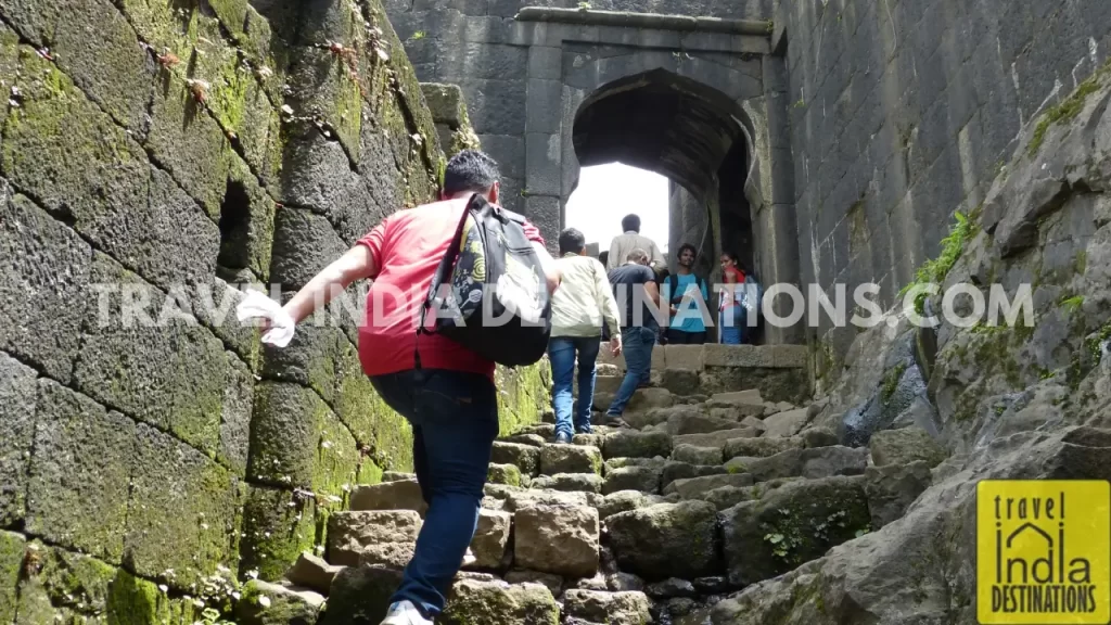 Trekkers approaching Hanuman Darwaza at the Lohagad Fort