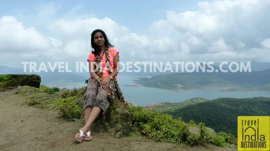 Sarah posing after Lohagad Fort trek with the backdrop of Pawna Lake