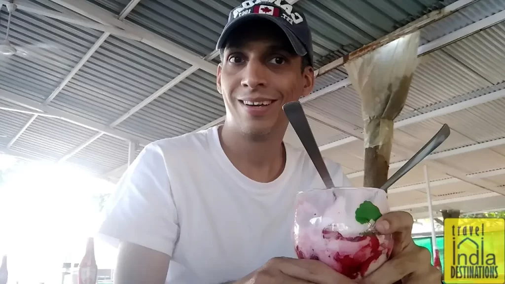 sharukh enjoying a strawberry milkshake at Mapro Garden one of the best places to visit in Lonavala