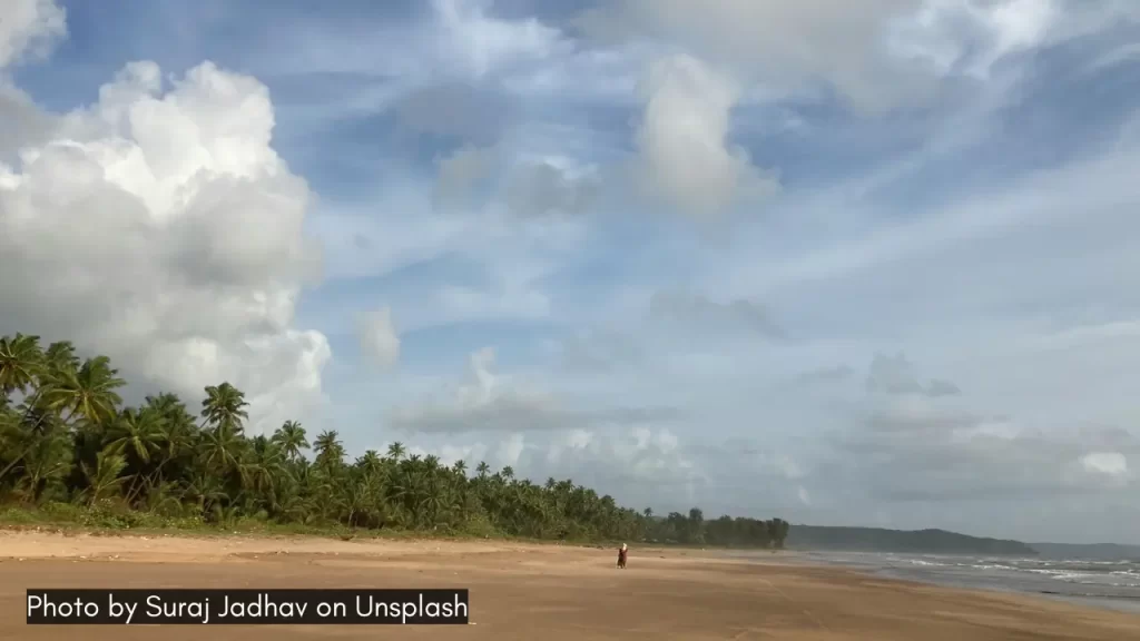 The pristine golden sand of the Guhagar Beach and clear skies