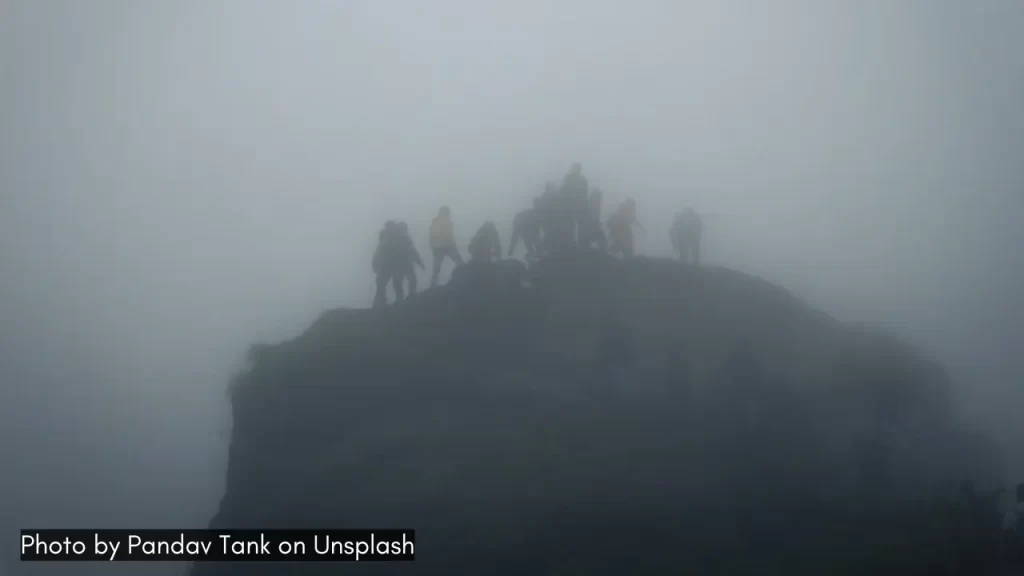 People on a hill in Saputara during the misty monsoon season.