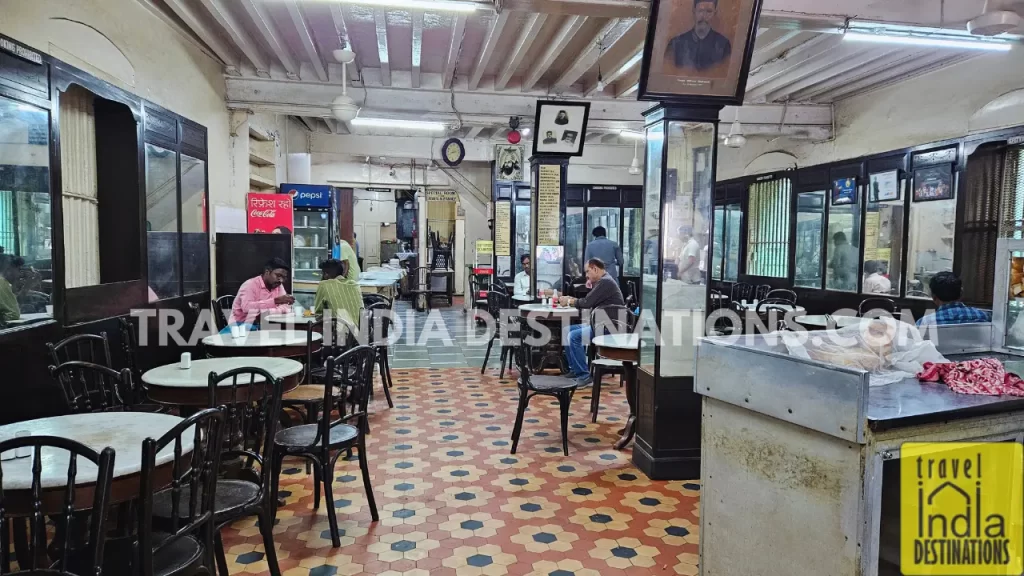 Interior of Merwan & Co. showcasing vintage marble-top tables and timeless Irani café charm