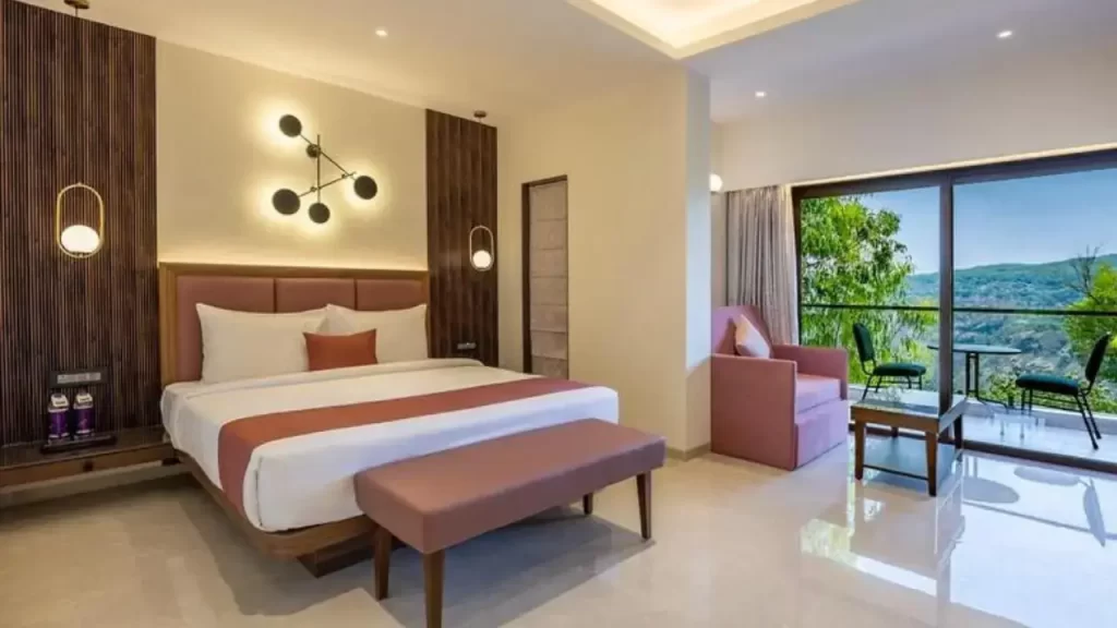 Elegant bedroom at Bella Vista Mahabaleshwar with balcony and modern interiors one of the best hotels in Mahabaleshwar