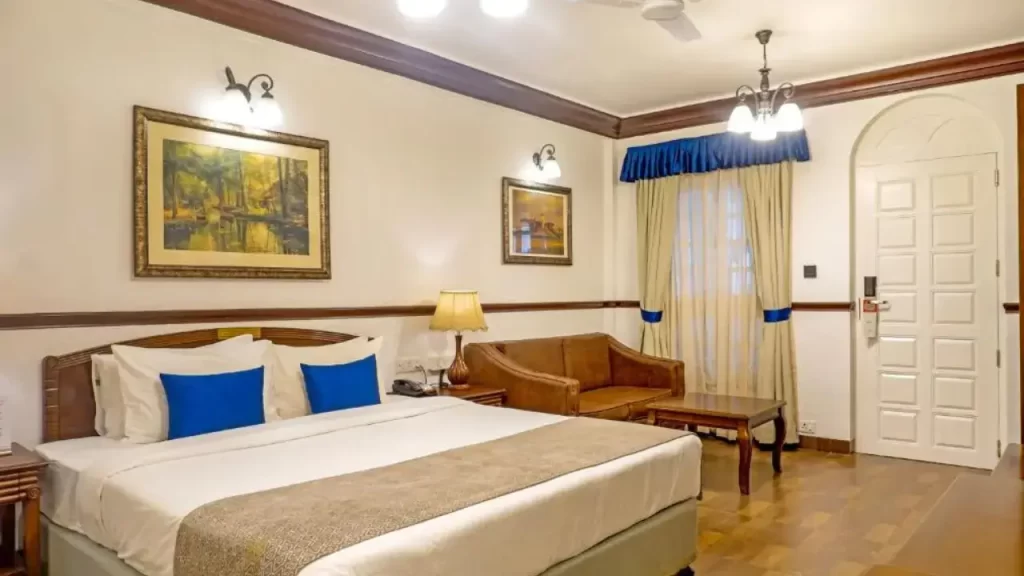 Elegant room at Citrus Chambers Mahabaleshwar with wall art, warm lighting, and full-length curtains