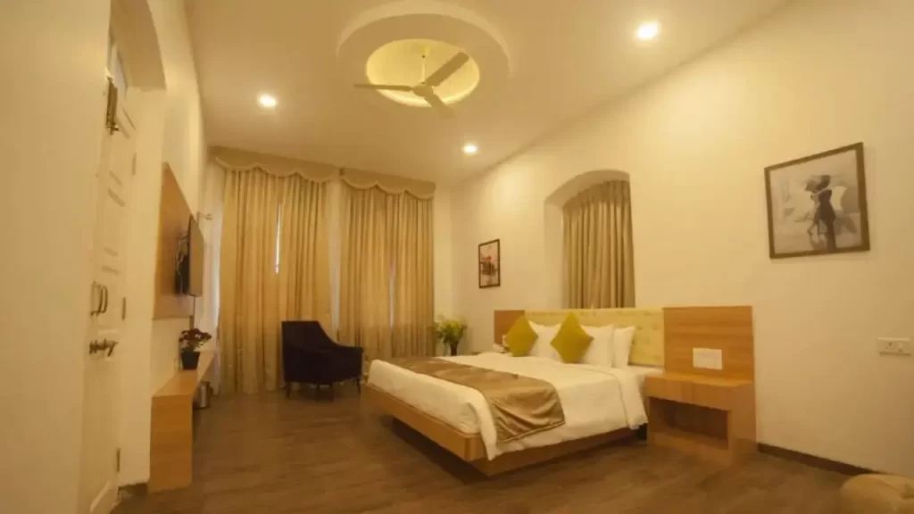 Stylish room at Regenta Place Green Leaf Mahabaleshwar with warm yellow-tone furnishings one of the best hotels in Mahabaleshwar for family