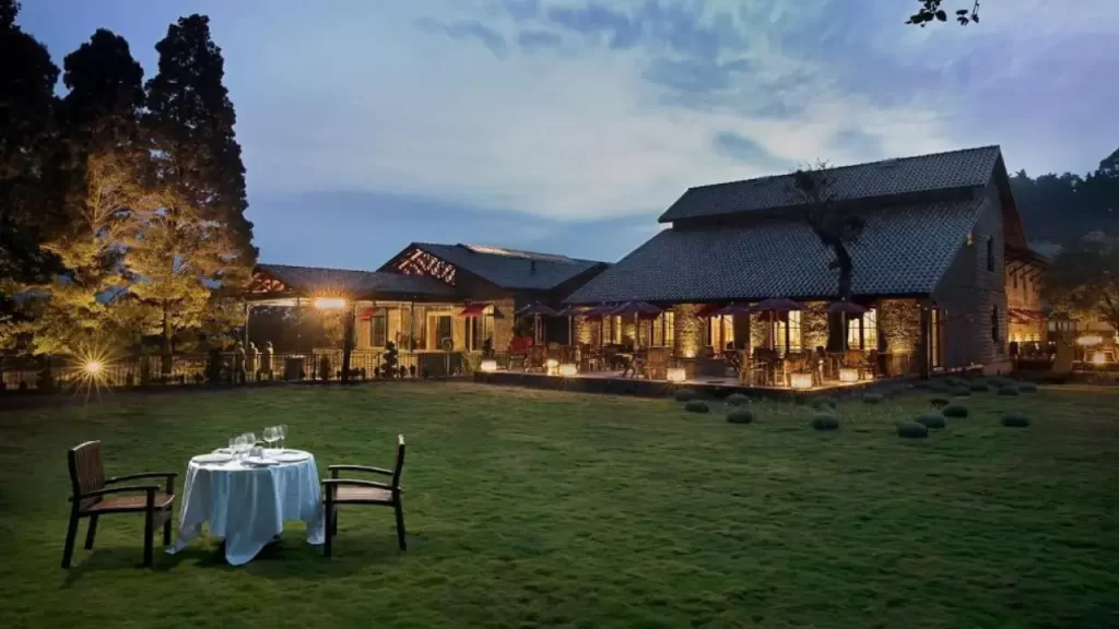A shot of Tamara Hilltop with chairs in the garden one of the luxury hotels near Kodaikanal Lake