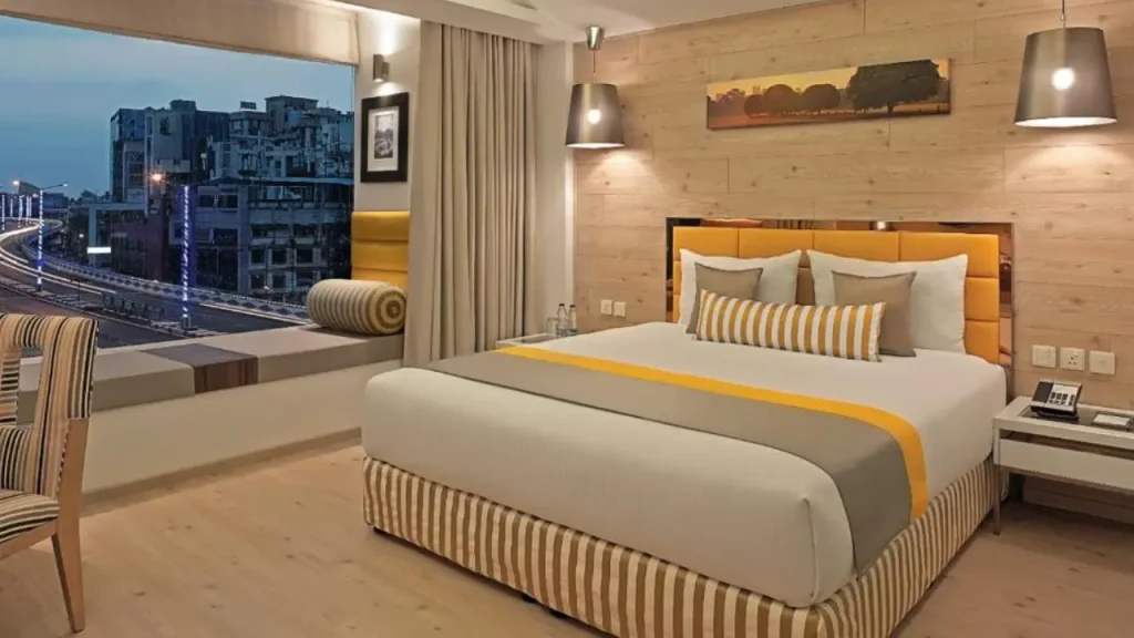 Spacious budget-friendly hotel room with city view at Barsana Boutique Hotel in Central Kolkata.