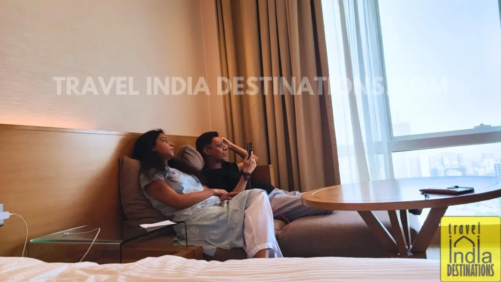 couple enjoying staycation looking outside the window at Westin Mumbai Garden City.