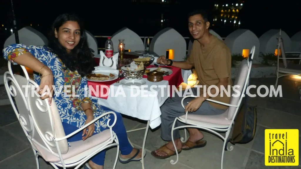 Couple enjoying lakeside fine dining at Tribute Restaurant in Udaipur.