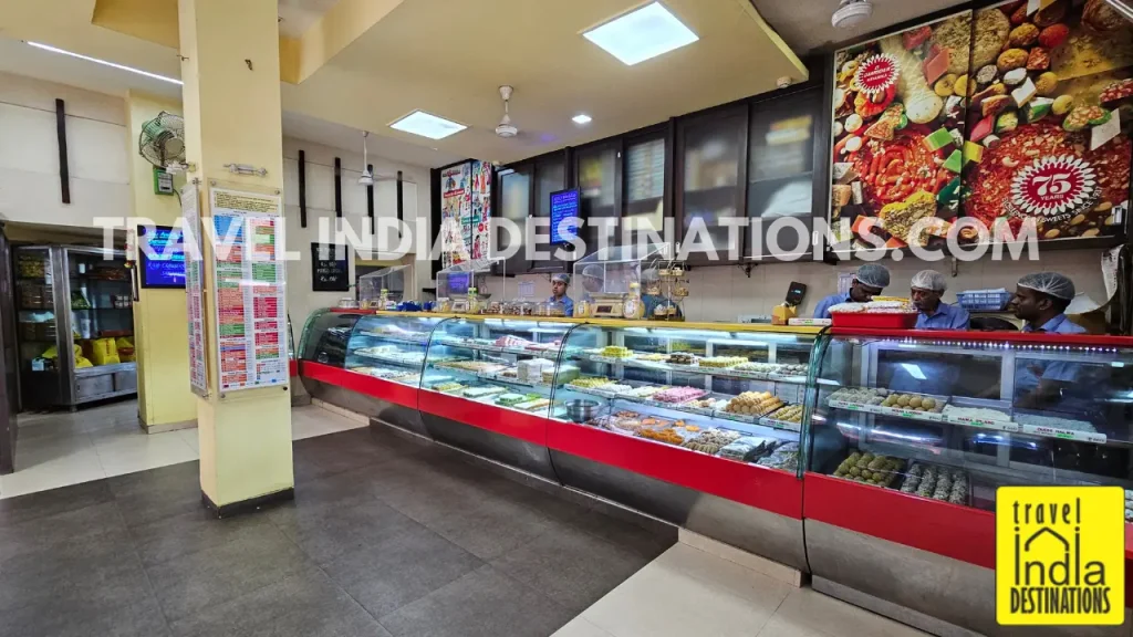 Interior of D. Damodar Mithaiwala in Mumbai showing colorful mithai and Indian sweets on display, perfect for Diwali, weddings, and festive celebrations.