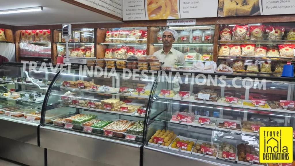 Interior of Punjabi Chandu Halwai in Mumbai showing colorful mithai and Indian sweets on display, perfect for Diwali, weddings, and festive celebrations.