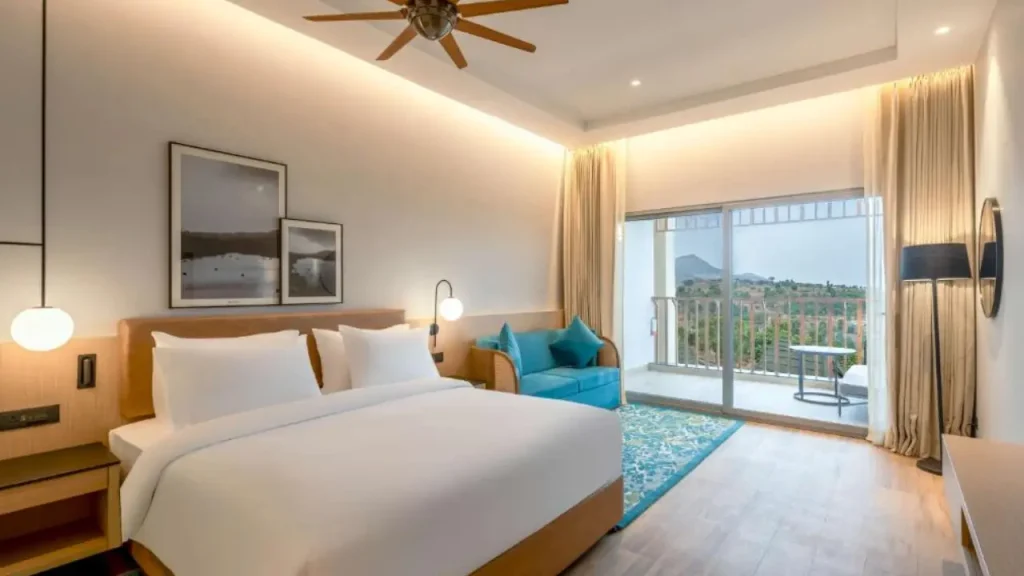 A view of the Executive Suite in Radisson Resort Hatgad Saputara furnished with modern amenities and a balcony.