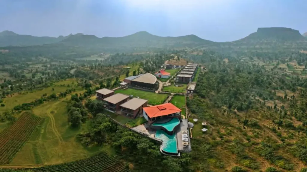 An aerial view of The Fern Heaven on the Hills Hatgad Saputara resort showcasing infinity swimming pool and the property.