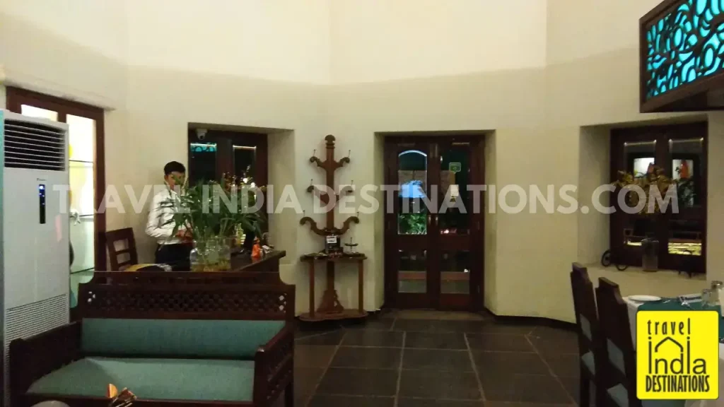 A picture of bistro and lounge area with sofas at 1559 AD Udaipur.