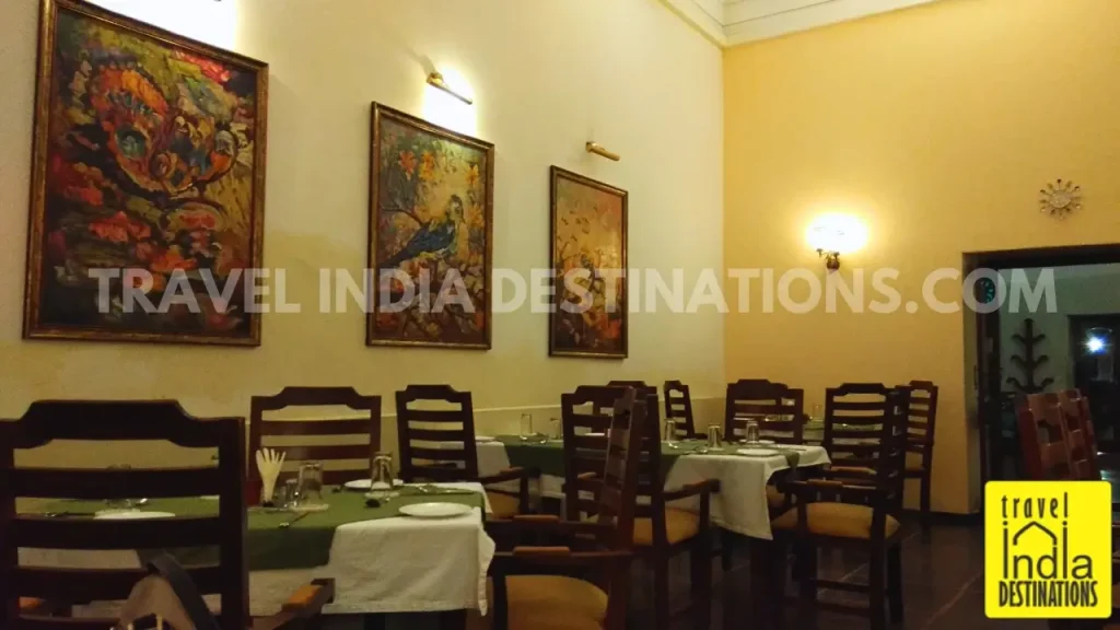 A shot of the elegant restaurant interiors with paintings at 1559 AD Udaipur.