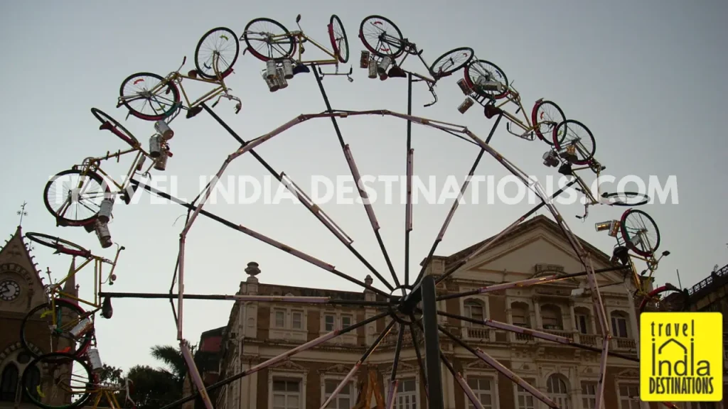 Giant ferris wheel installation with bicycles and Mumbai dabbas at Kala Ghoda Arts Festival.