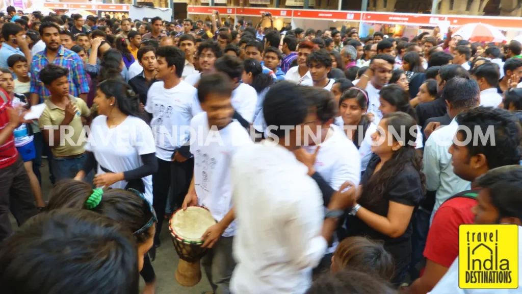 Audience enjoying street performers and interactive street drama at Kala Ghoda Arts Festival.