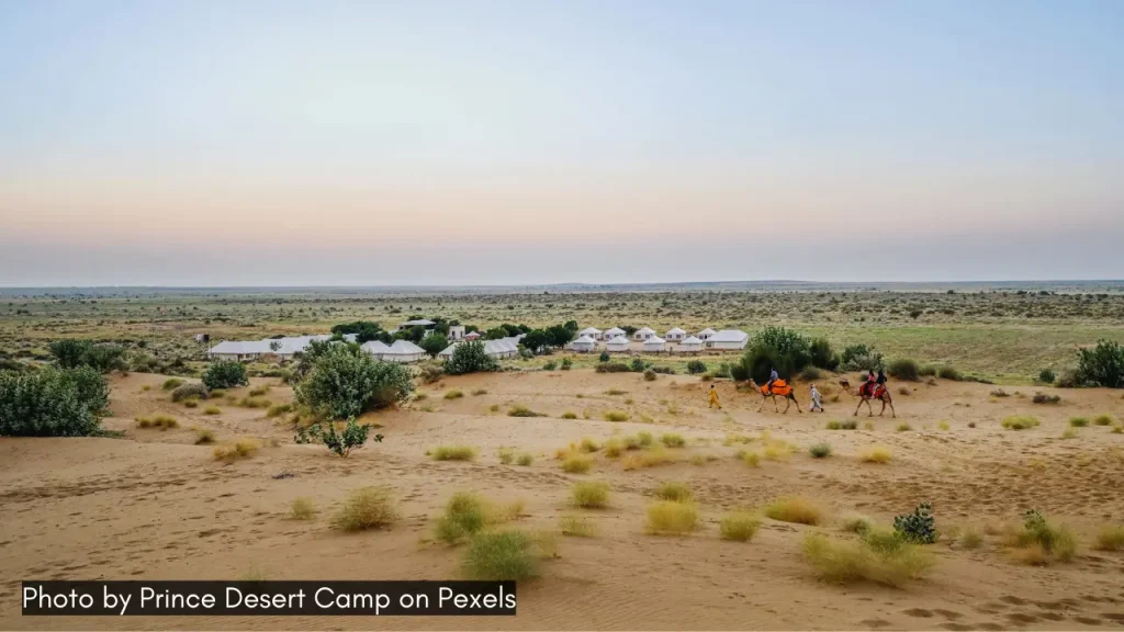 A panoramic landscape shot of Jaisalmer with desert camping facilities and camel rides.