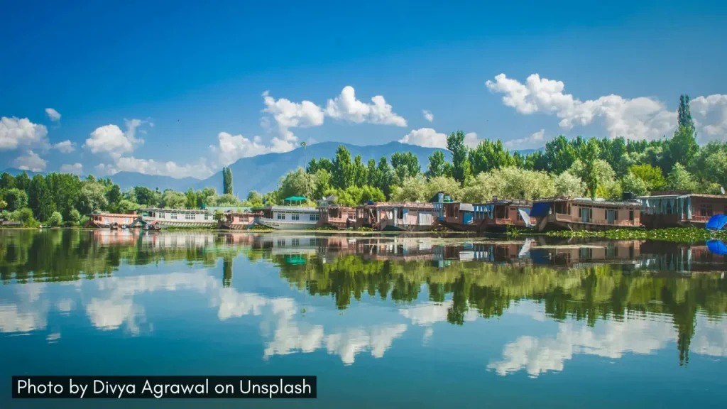 A picture of house boats reflected in the still waters of Dal Lake in Srinagar Jammu and Kashmir, one of the best honeymoon destinations in India in March.
