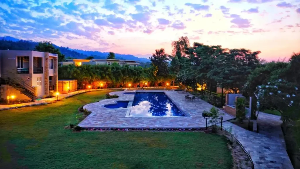 The Golden Tusk lodge exterior with pool and forest view, Jim Corbett National Park