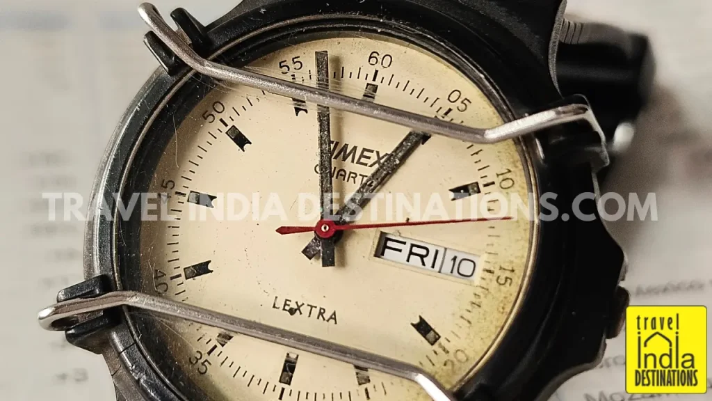 Close-up of Timex Lextra watch dial with scratches and metal guard