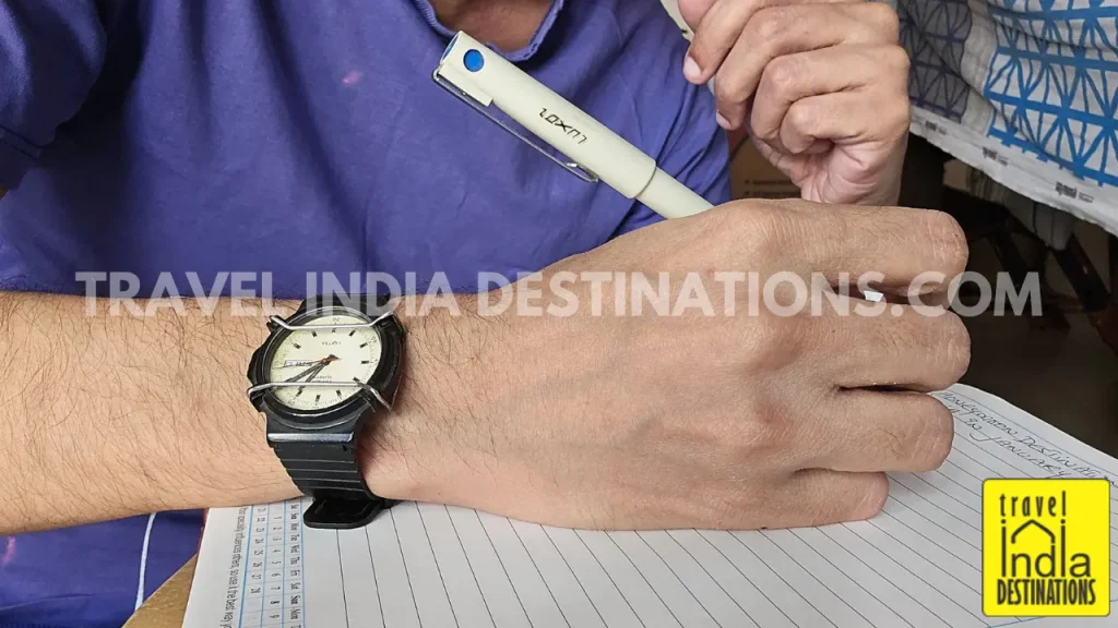 Wearing Timex Lextra watch while writing a book with Luxor Pilot pen.