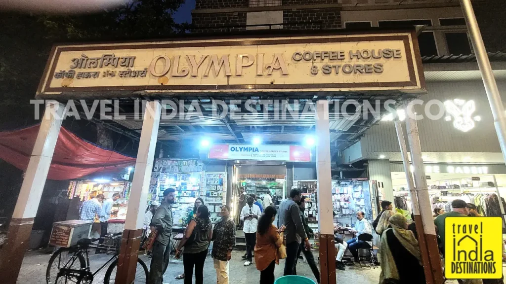 A view of people interacting socially outside Olympia Coffee House in Colaba Mumbai, one of the best places for biryani in Mumbai.