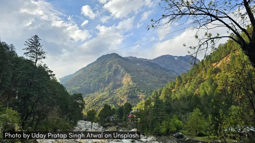 A panoramic landscape shot of Tirthan Valley in Himachal Pradesh, one of the best places to visit in April in India.