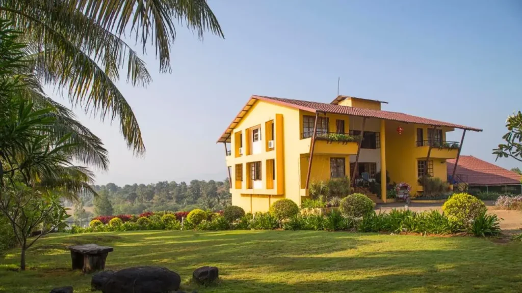 Exteriors of Vallonne Vineyards, a wine estate in Igatpuri offering sweeping view of vineyards and lake beyond.