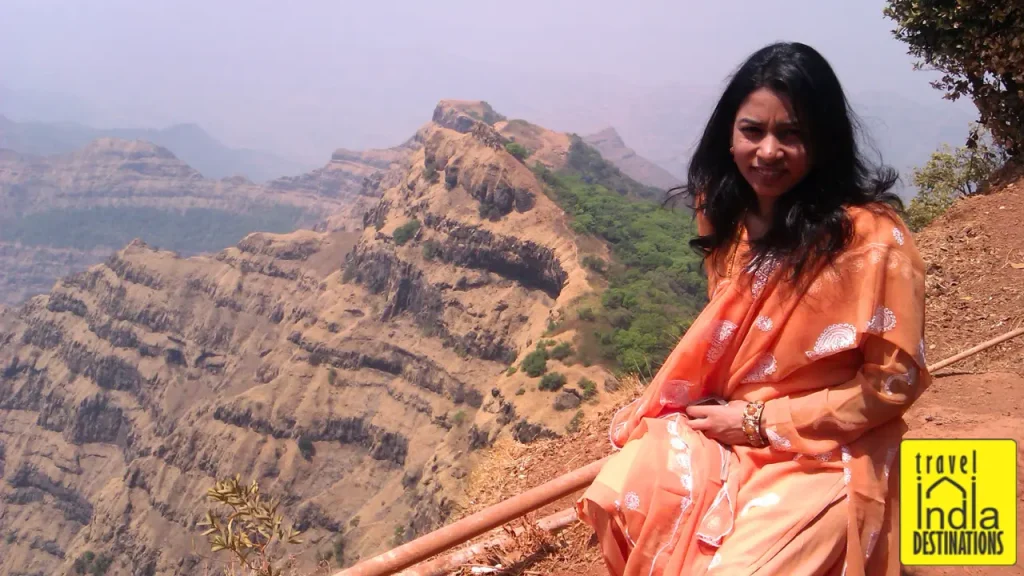 A woman posing before the scenic view in Mahabaleshwar.