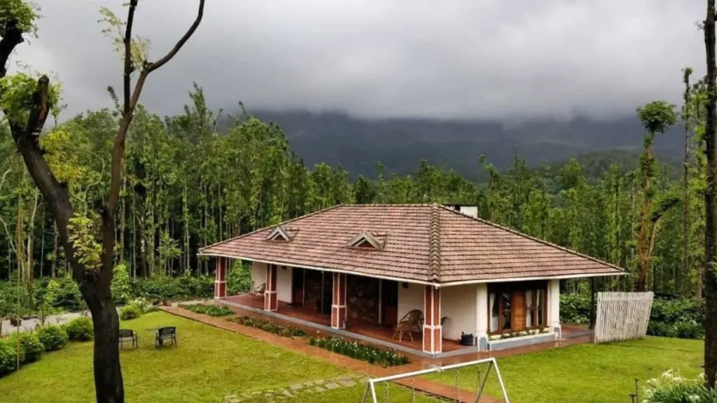 Simple exteriors of Halli Berri Cottages one of the best homestays in Chikmagalur with monsoon clouds hovering in the background.