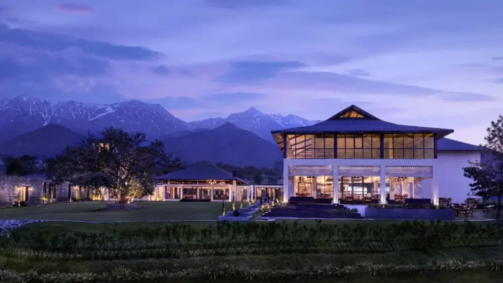 Exteriors of Storii by ITC Hotels, Amoha Retreats in Dharamshala with surrounding snow-capped mountains ideal for minimooners in April.