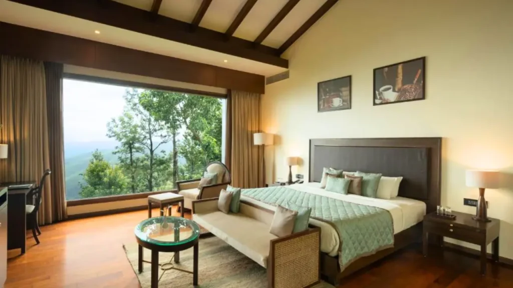 Cozy interiors of the Mountain Room at Trivik Hotels & Resorts in Chikmagalur offering pristine mountain views.