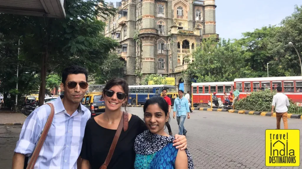 Sharukh, Sarah and Iris outside Regal Cinema in Colaba, Mumbai with Majestic House in the background.
